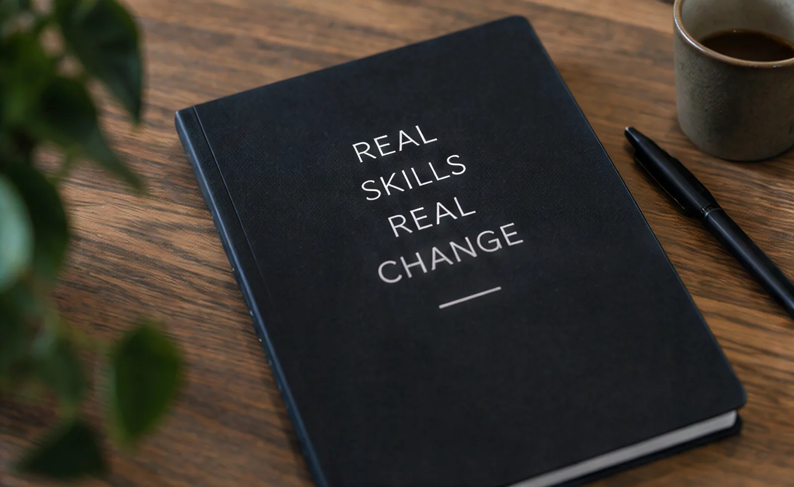 A notebook with the words Real skills, real change